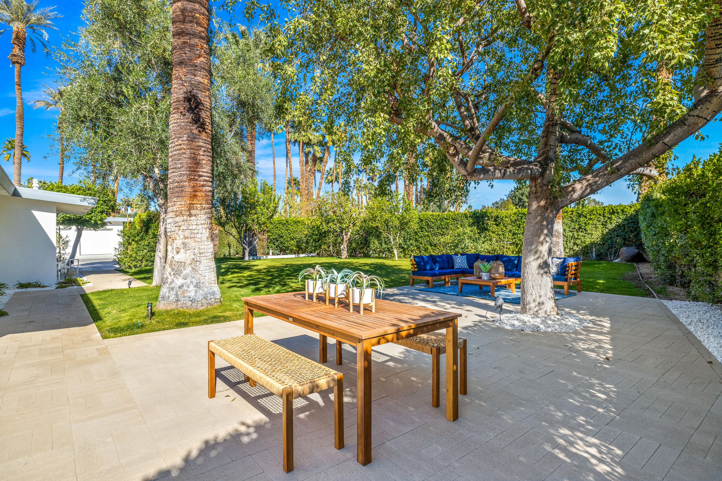 37521 Palm View Road Rancho Mirage, CA 92270 - Photo 44 of 61 a view of a patio with table and chairs potted plants and large tree