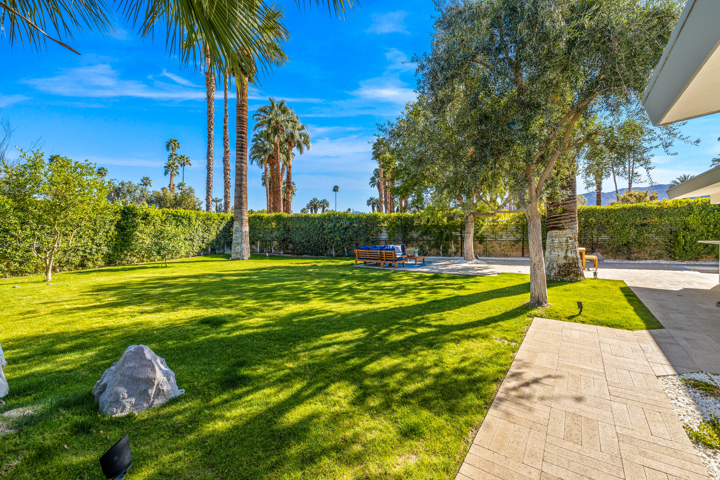 37521 Palm View Road Rancho Mirage, CA 92270 - Photo 51 of 61 a view of a swimming pool with a garden and palm trees