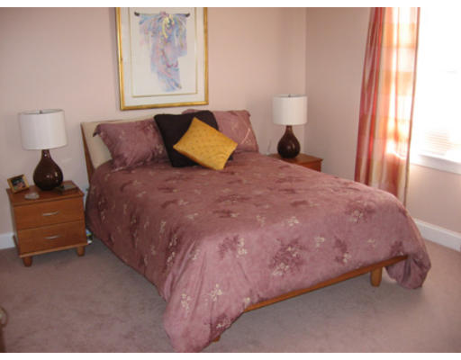 28 Beechwood Road Lynnfield, MA 01940 - Photo 7 of 11 a large bed sitting in a bedroom next to a window