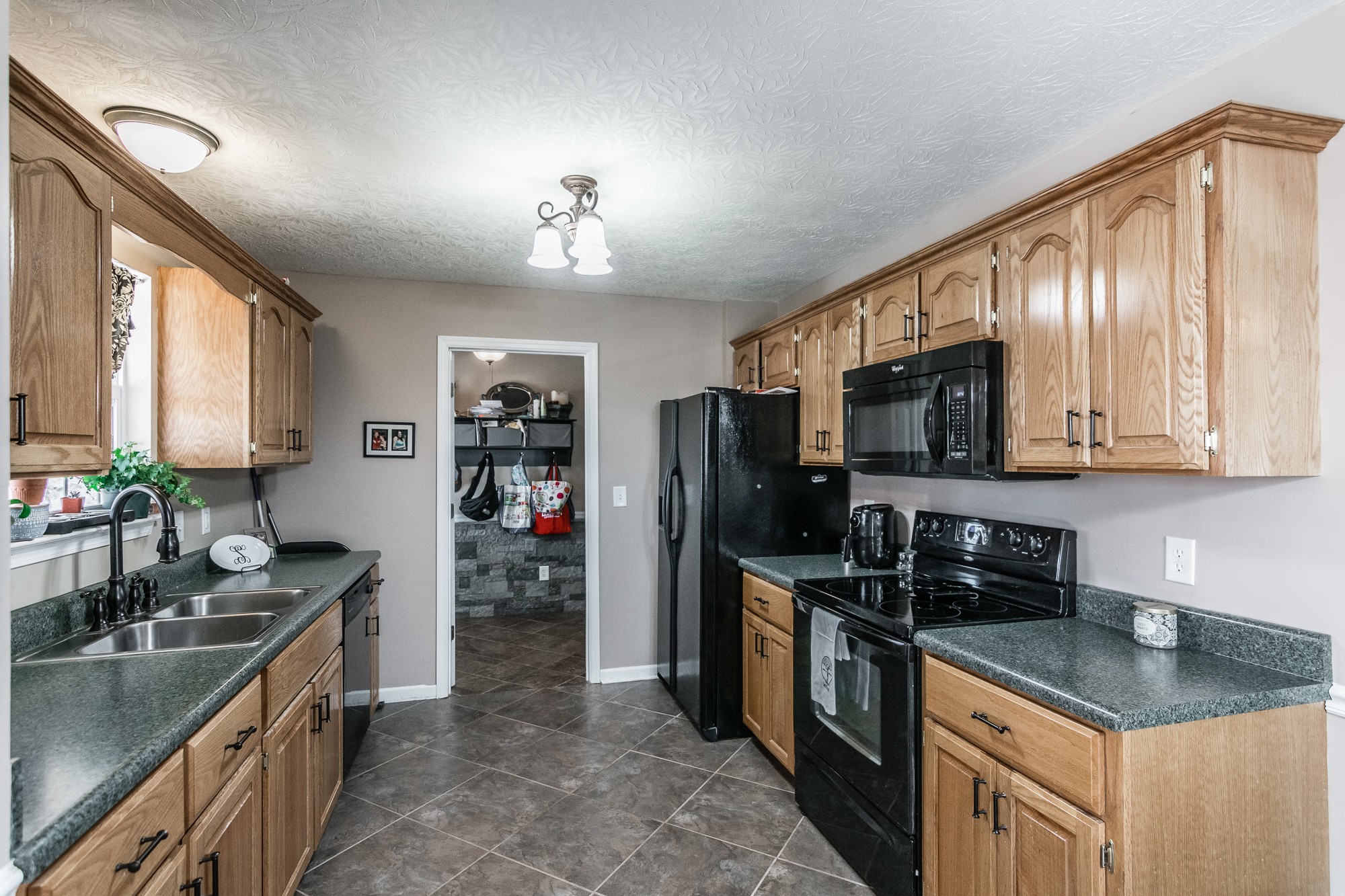 166 Switchboard Road Portland, TN 37148 - Photo 11 of 49 a kitchen with stainless steel appliances granite countertop a sink stove and refrigerator