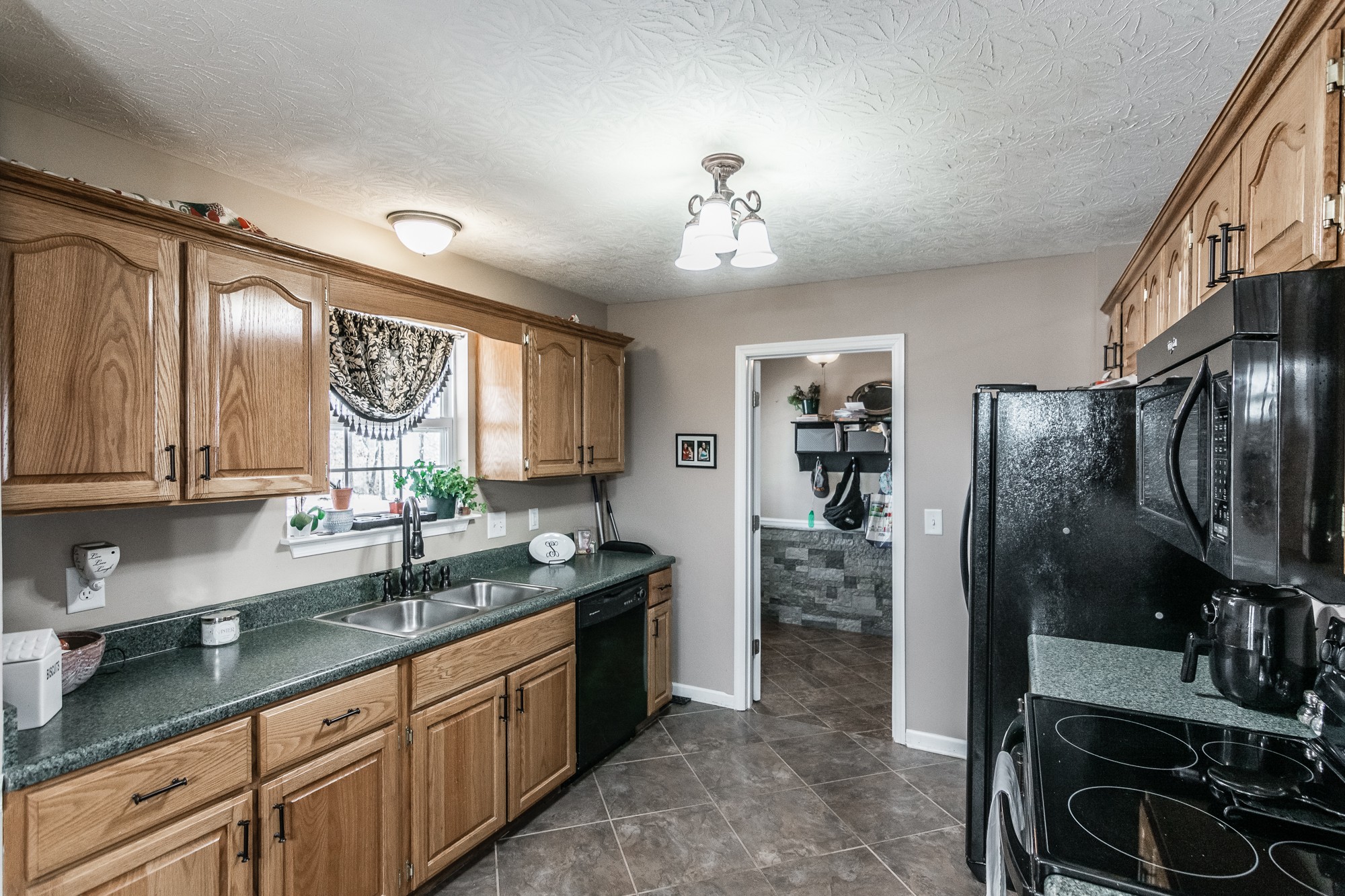 166 Switchboard Road Portland, TN 37148 - Photo 12 of 49 a kitchen with granite countertop a sink stainless steel appliances and cabinets
