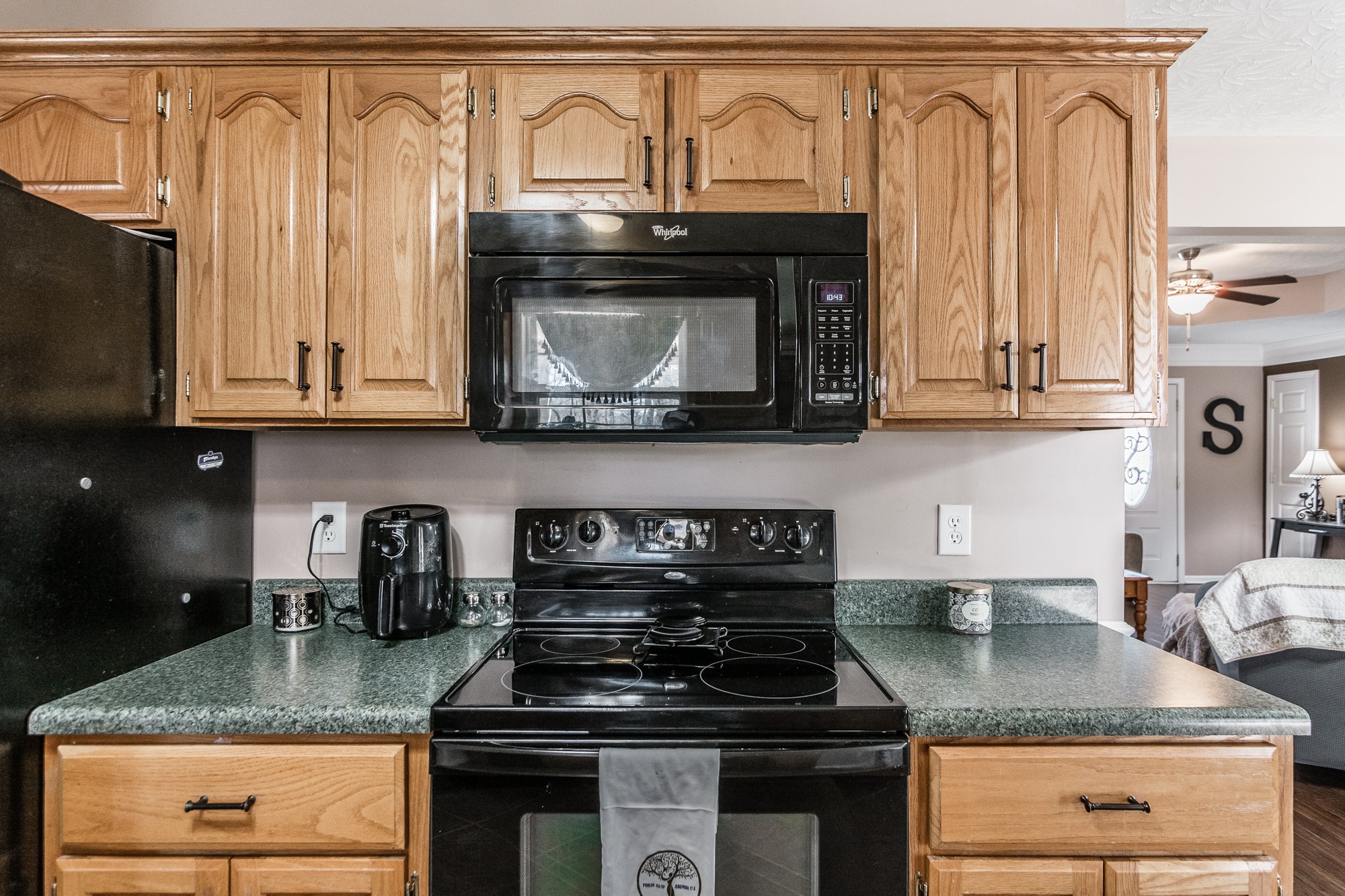 166 Switchboard Road Portland, TN 37148 - Photo 15 of 49 a kitchen with granite countertop a stove top oven microwave and cabinets