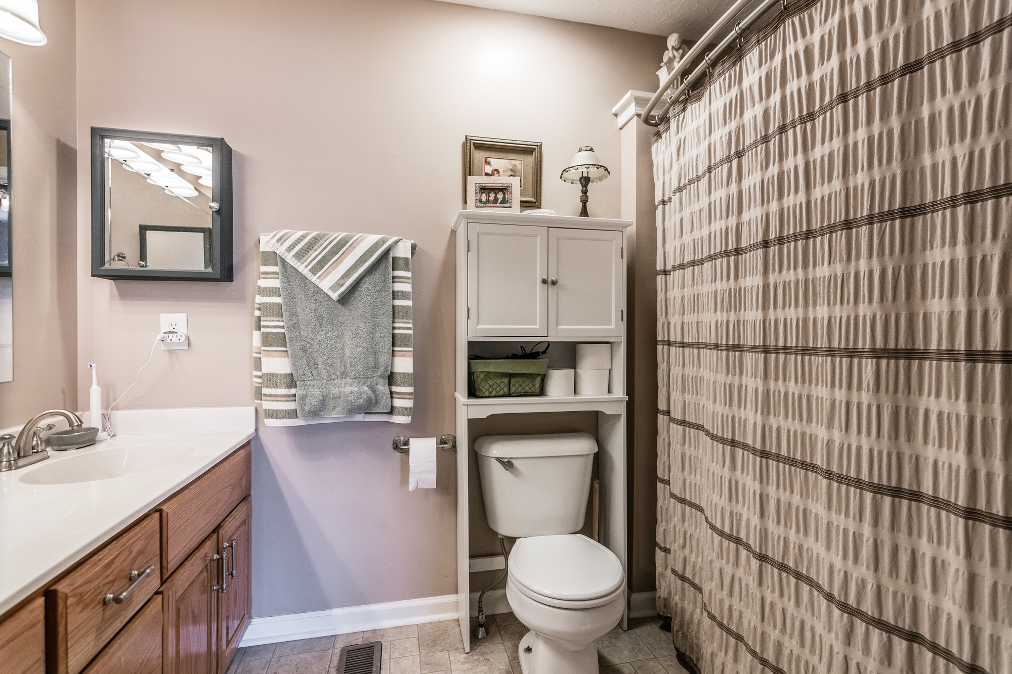 166 Switchboard Road Portland, TN 37148 - Photo 24 of 49 a bathroom with a toilet sink vanity and mirror