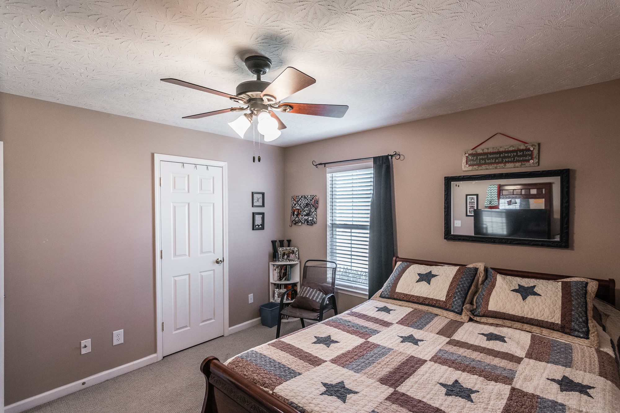 166 Switchboard Road Portland, TN 37148 - Photo 27 of 49 a bedroom with a bed and a chandelier