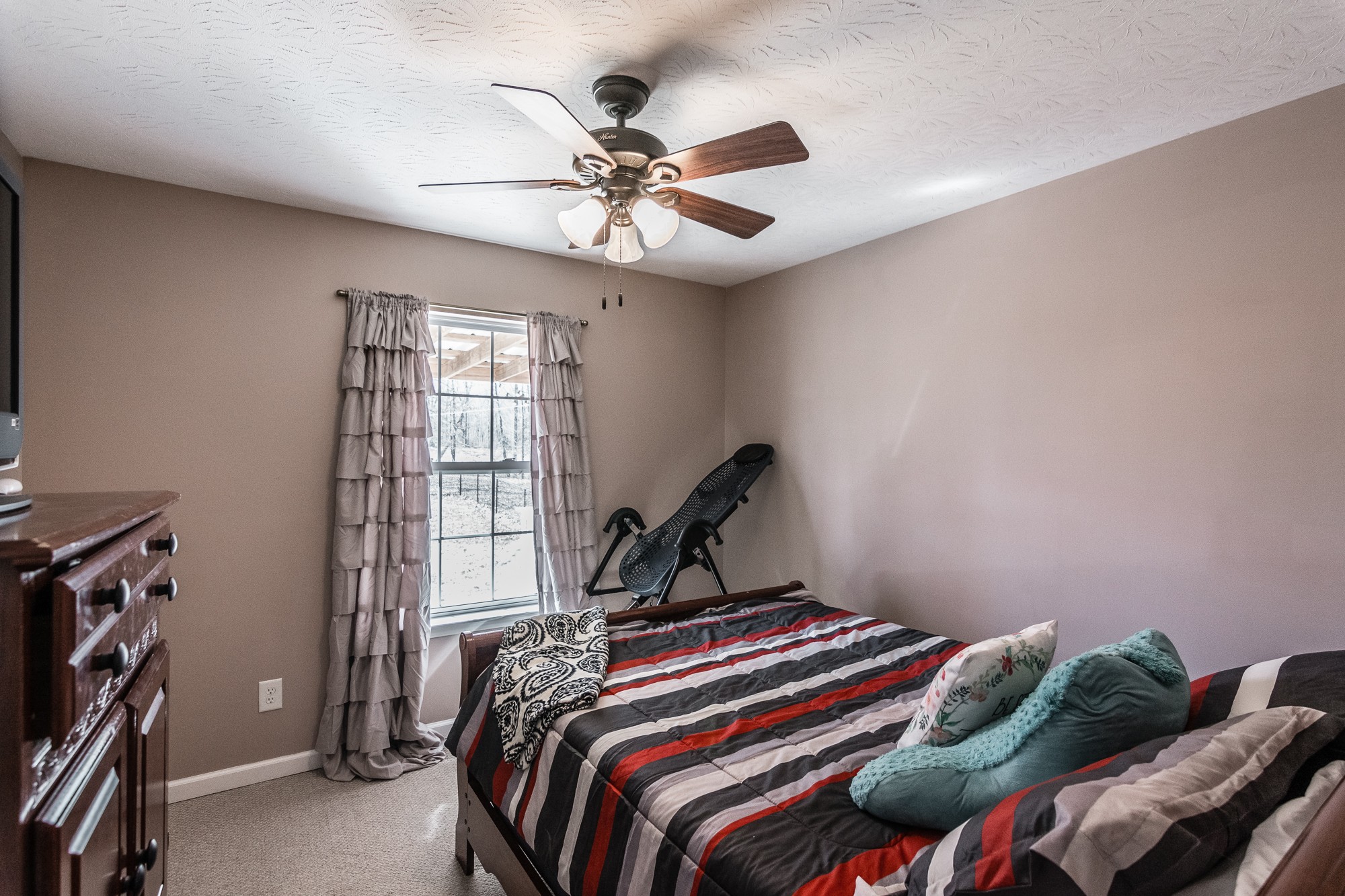 166 Switchboard Road Portland, TN 37148 - Photo 28 of 49 a bedroom with a bed and a chandelier