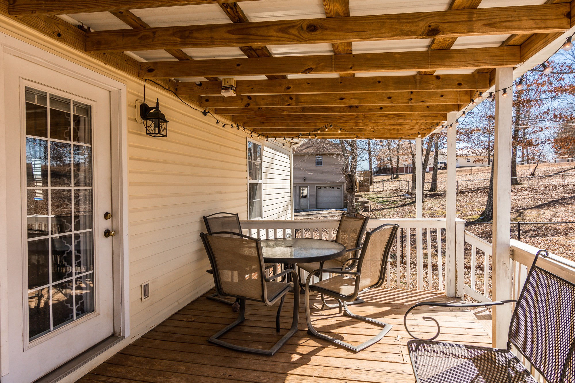 166 Switchboard Road Portland, TN 37148 - Photo 37 of 49 a view of a roof deck with table and chairs with wooden floor