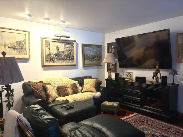 a view of kitchen with stainless steel appliances granite countertop sink and cabinets