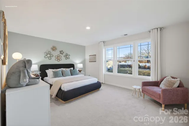 a bedroom with a large bed and a window