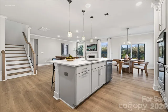 a kitchen with a sink appliances and cabinets