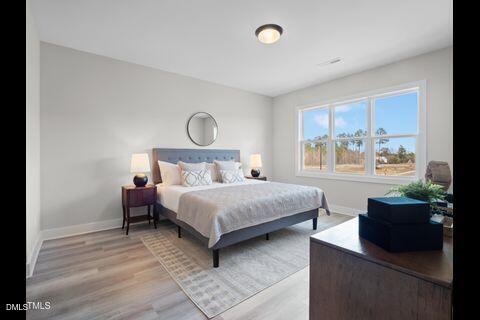 2126 Titanium Rock Road Durham, NC 27704 - Photo 14 of 20 a bedroom with a bed and a window