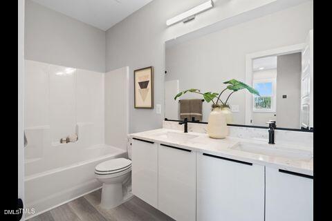 2126 Titanium Rock Road Durham, NC 27704 - Photo 20 of 20 a bathroom with a granite countertop toilet sink and mirror