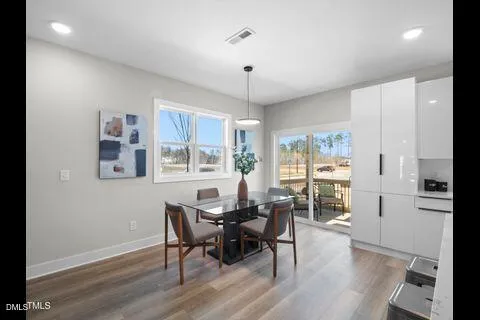 a view of a dining room with furniture window and wooden floor