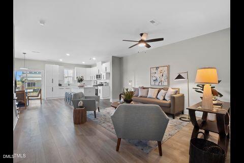 2126 Titanium Rock Road Durham, NC 27704 - Photo 6 of 20 a living room with furniture a table and wooden floor