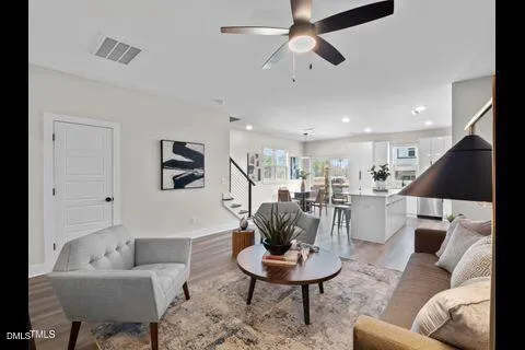a living room with furniture and a dining table