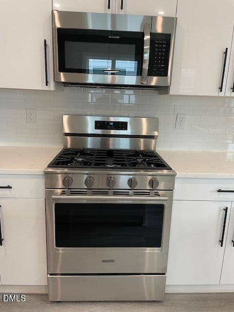 2126 Titanium Rock Road Durham, NC 27704 - Photo 8 of 20 a stove top oven sitting inside of a kitchen