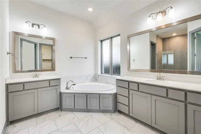 a spacious bathroom with a double vanity sink mirror and
