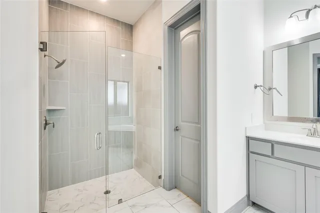 a bathroom with a shower and a sink