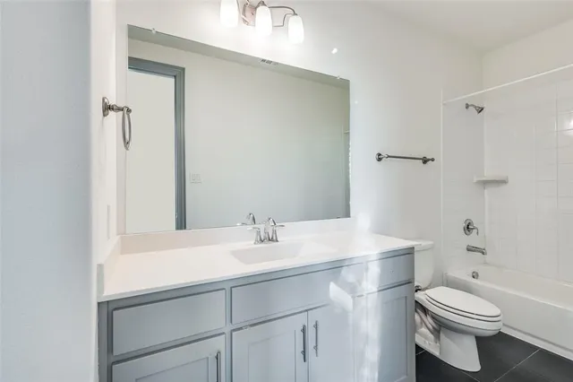 a bathroom with a sink a toilet a shower and a mirror