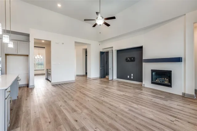 a view of empty room with wooden floor and fireplace