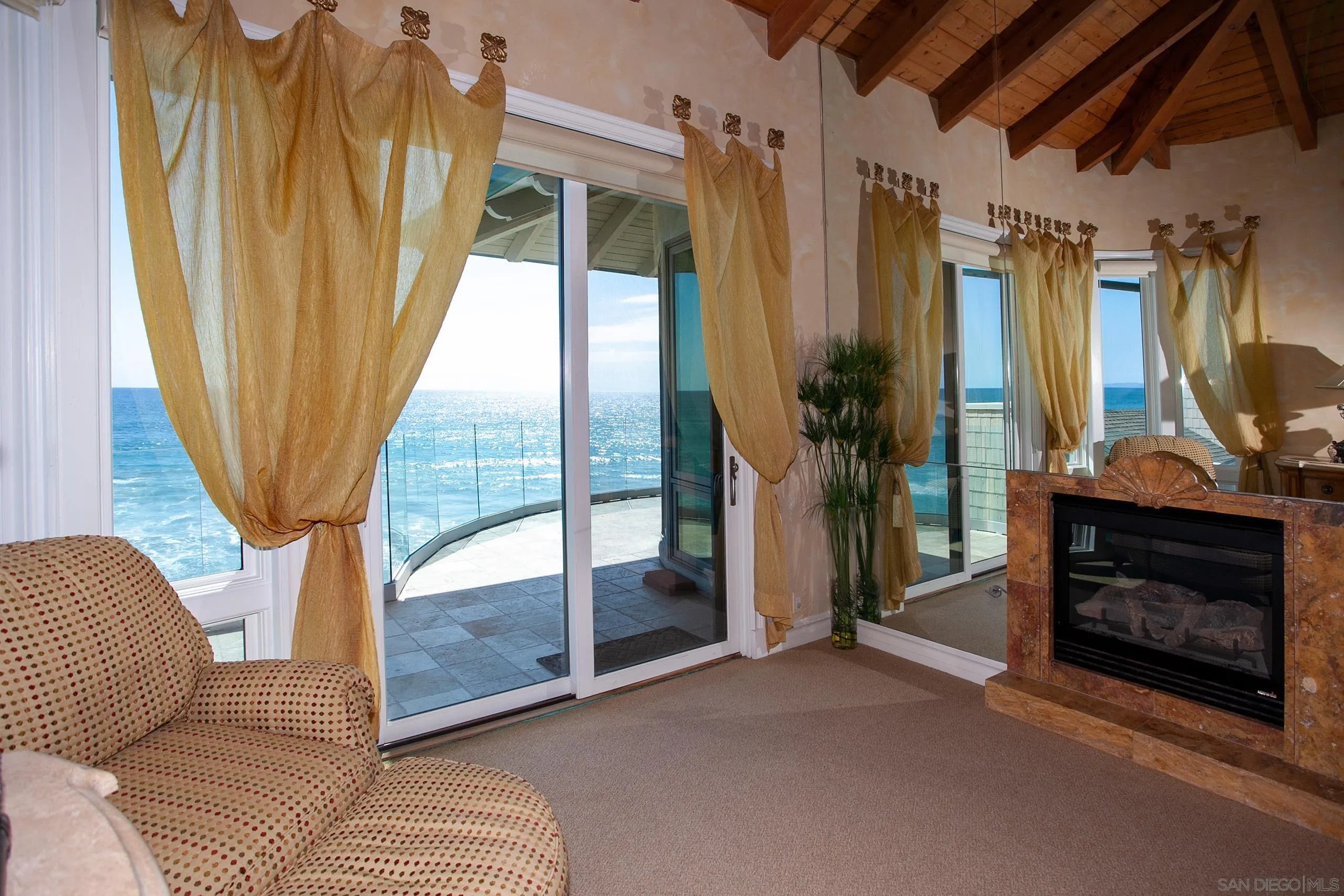 2901 Ocean Street, Unit 3 Carlsbad, CA 92008 - Photo 16 of 29 a living room with a fireplace furniture and a large window