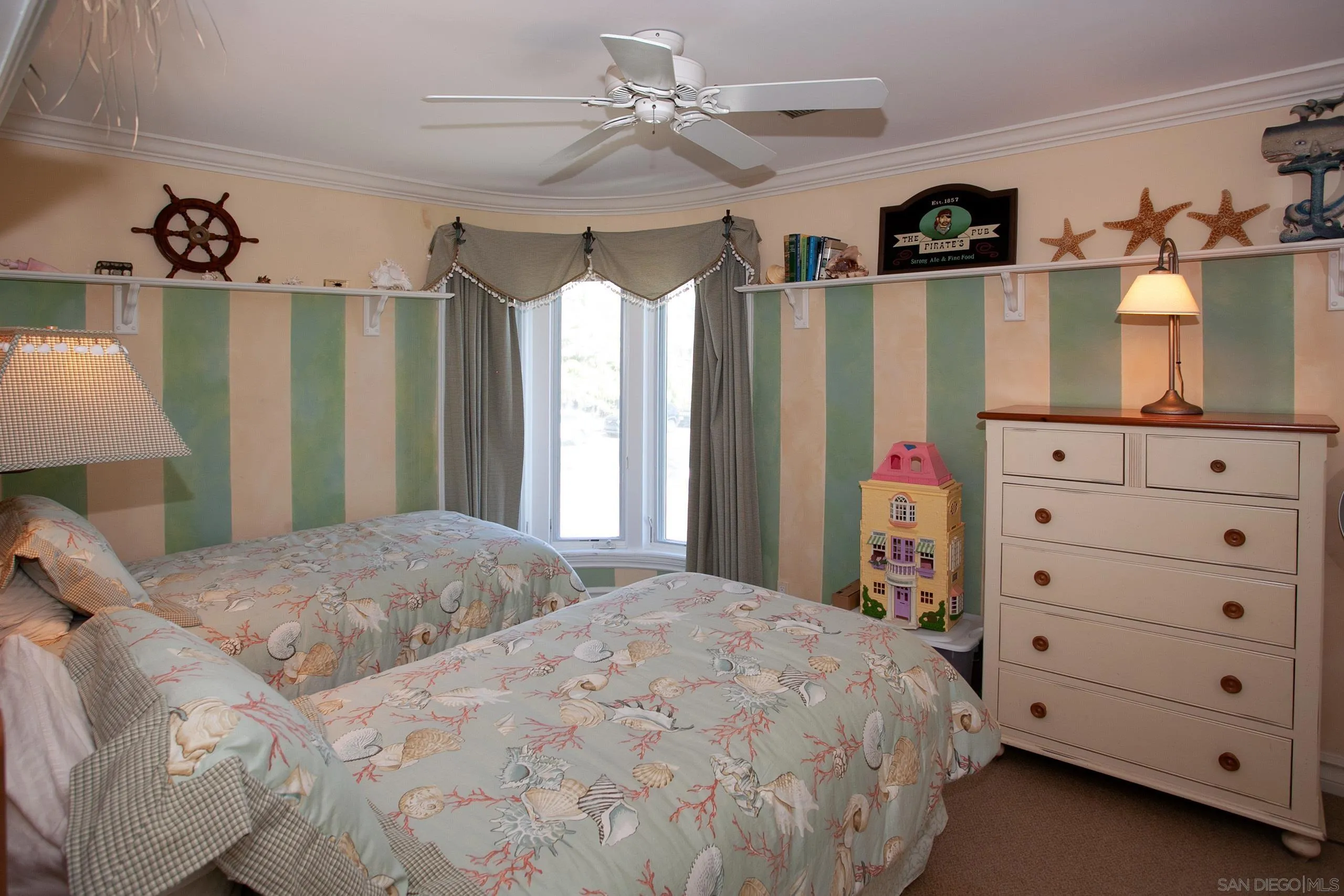 2901 Ocean Street, Unit 3 Carlsbad, CA 92008 - Photo 20 of 29 a bedroom with a bed a dresser and a window
