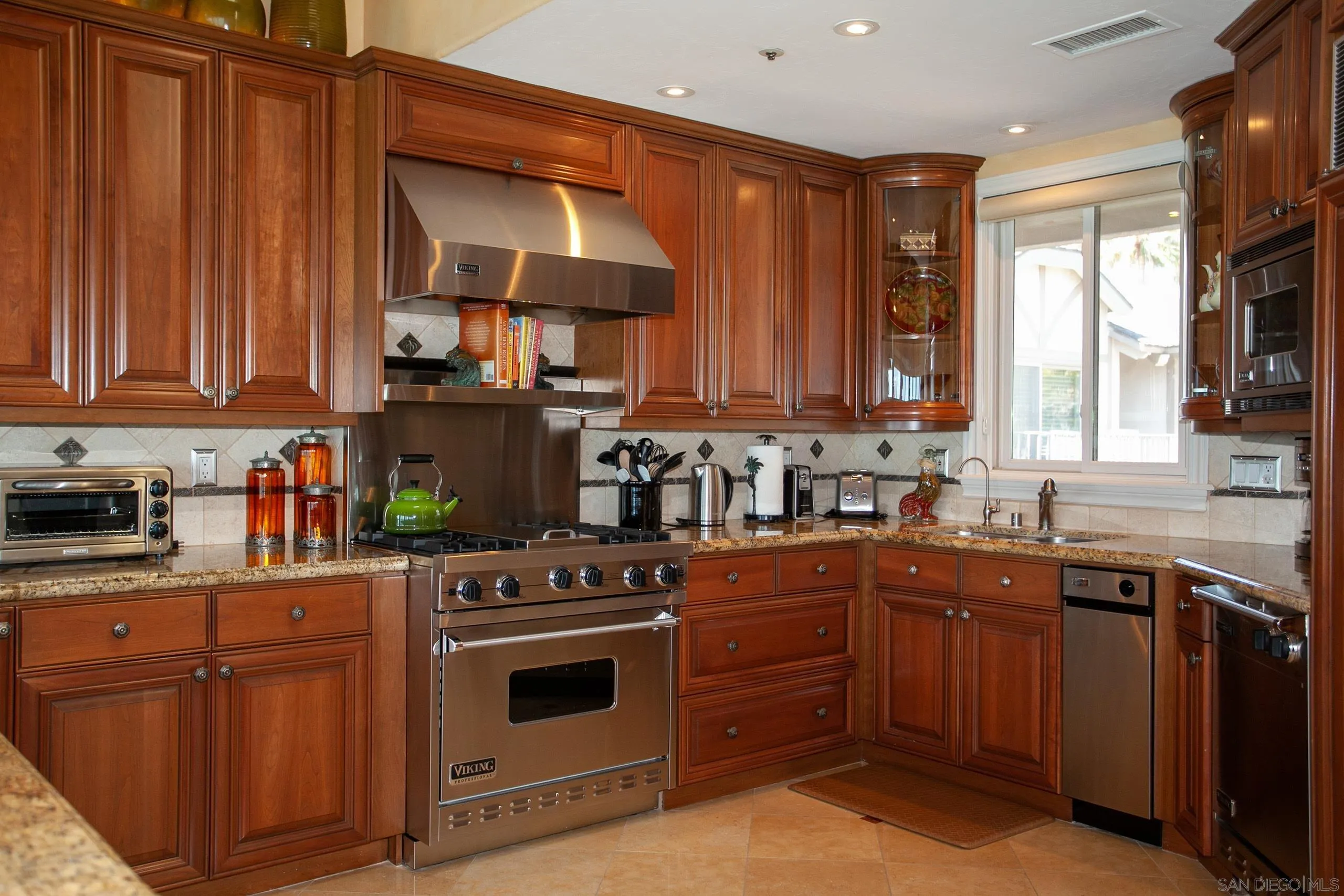 2901 Ocean Street, Unit 3 Carlsbad, CA 92008 - Photo 6 of 29 a kitchen with a sink stove top oven and cabinets