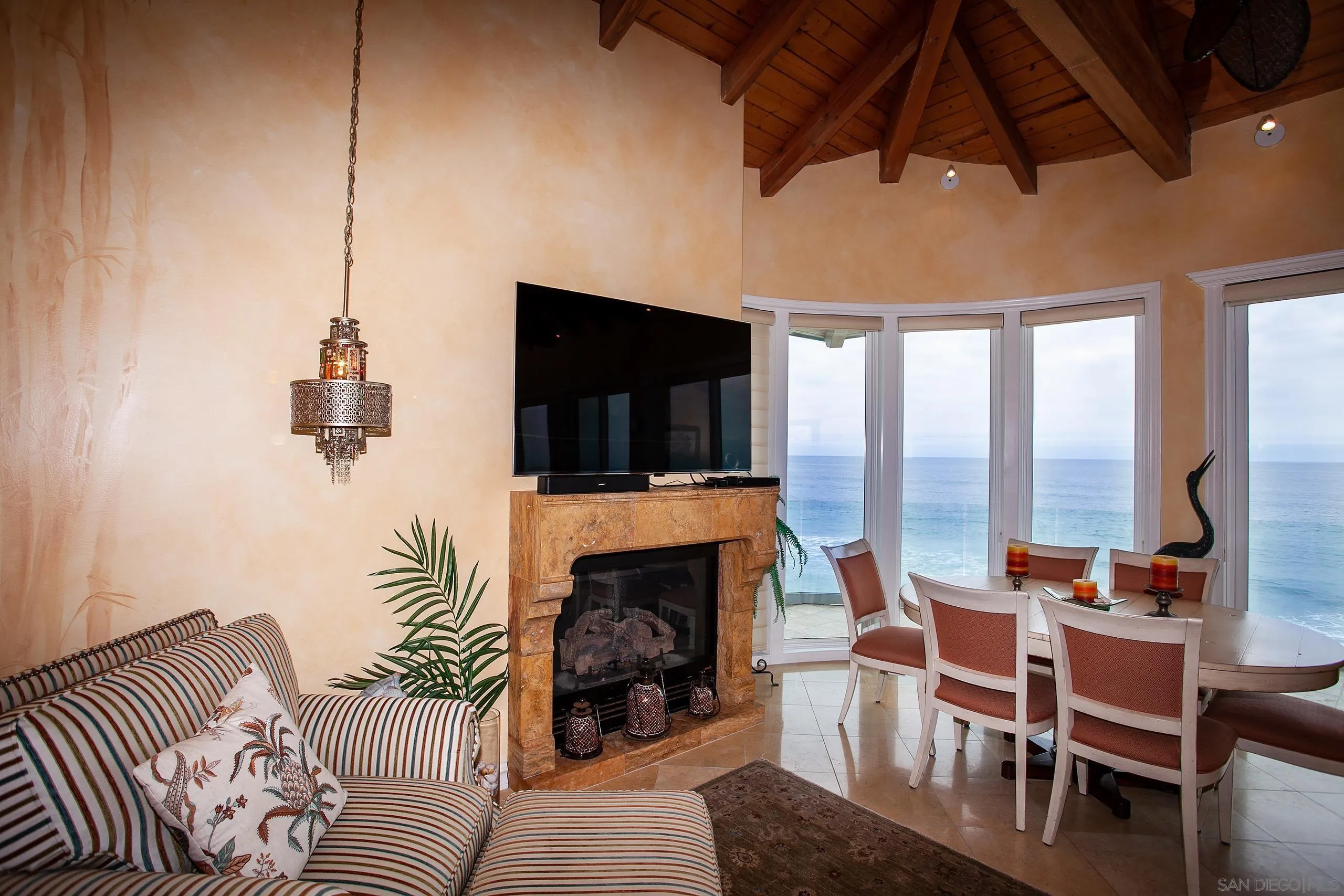 2901 Ocean Street, Unit 3 Carlsbad, CA 92008 - Photo 7 of 29 a living room with furniture a flat screen tv and a fireplace