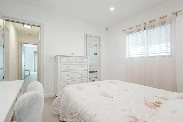 a bed sitting in a bedroom next to a desk
