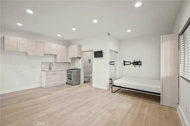 a kitchen with white cabinets and a stove