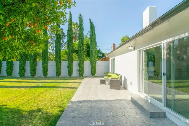 a view of swimming pool with a backyard and trees