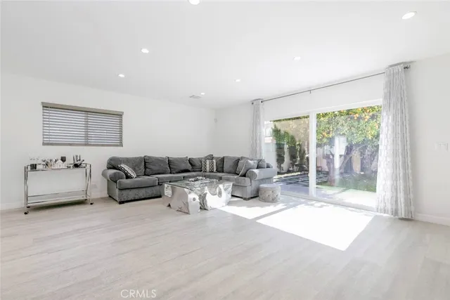 a living room with furniture and large windows