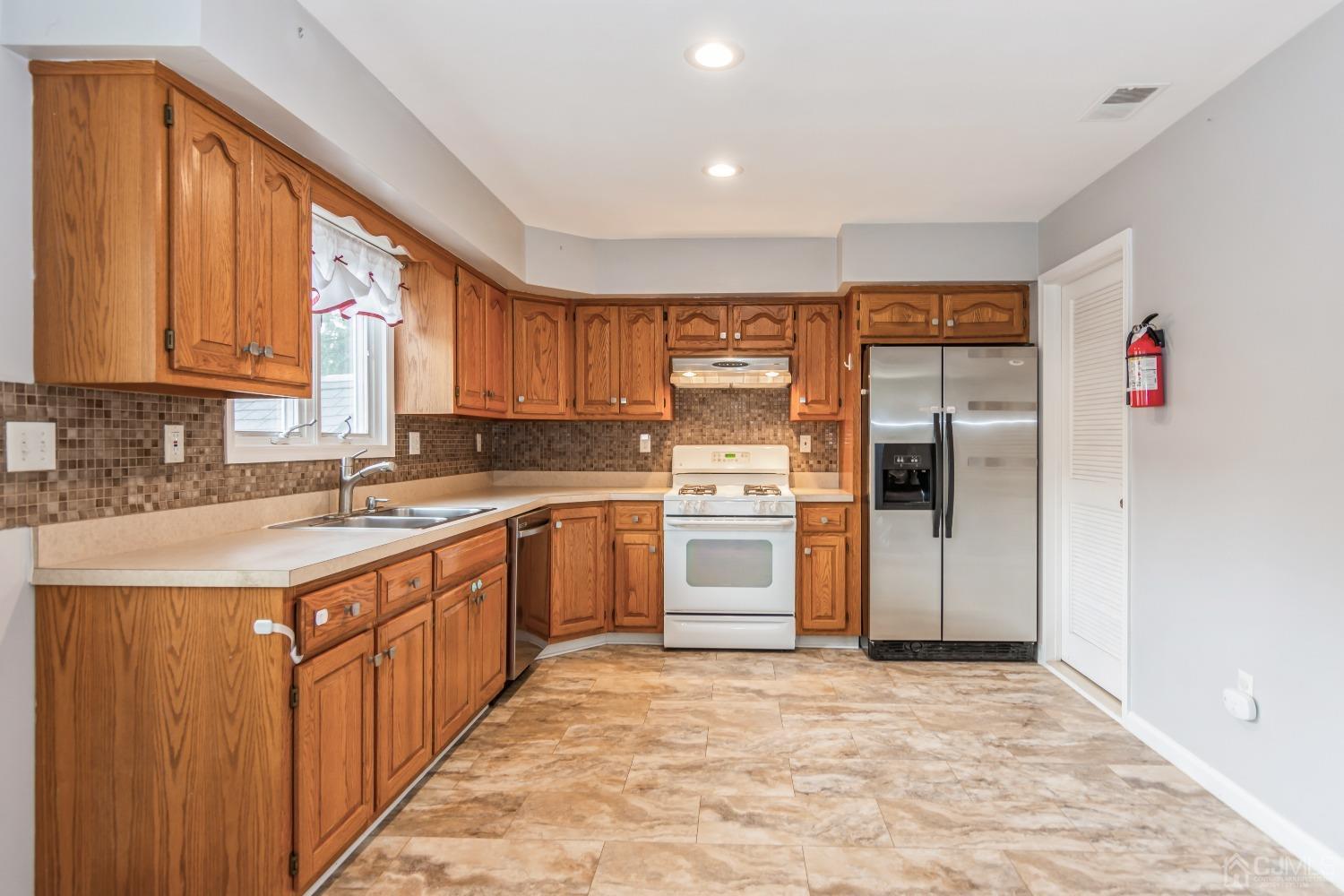 640 Bound Brook Road Middlesex, NJ 08846 - Photo 8 of 23 a kitchen with stainless steel appliances granite countertop a refrigerator and a sink