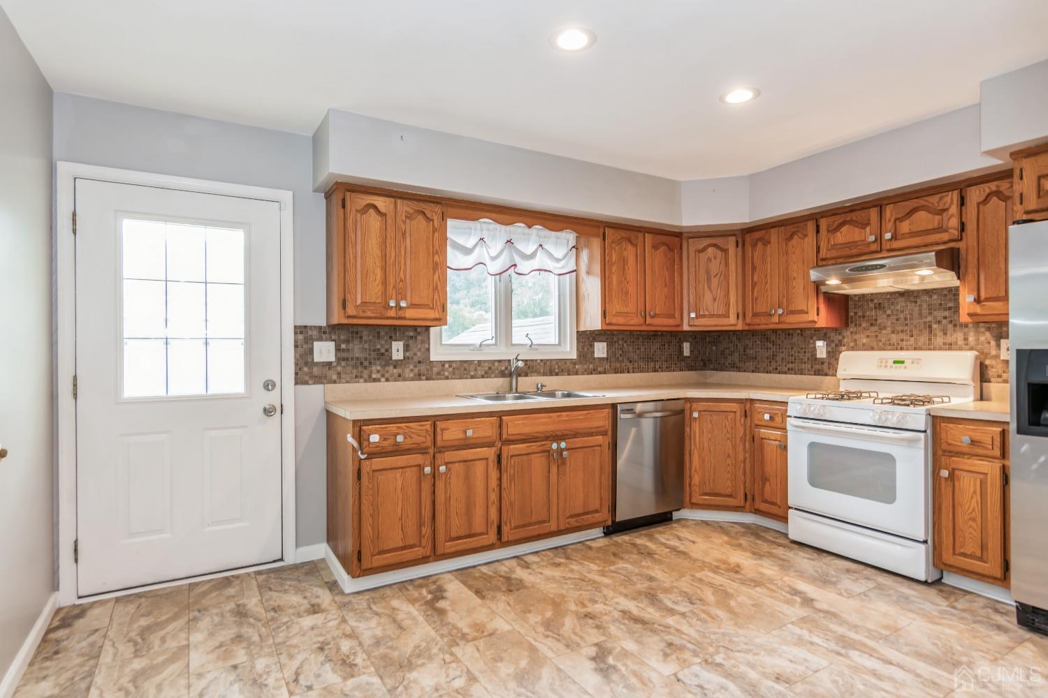 640 Bound Brook Road Middlesex, NJ 08846 - Photo 9 of 23 a kitchen with stainless steel appliances granite countertop a stove a sink and a refrigerator