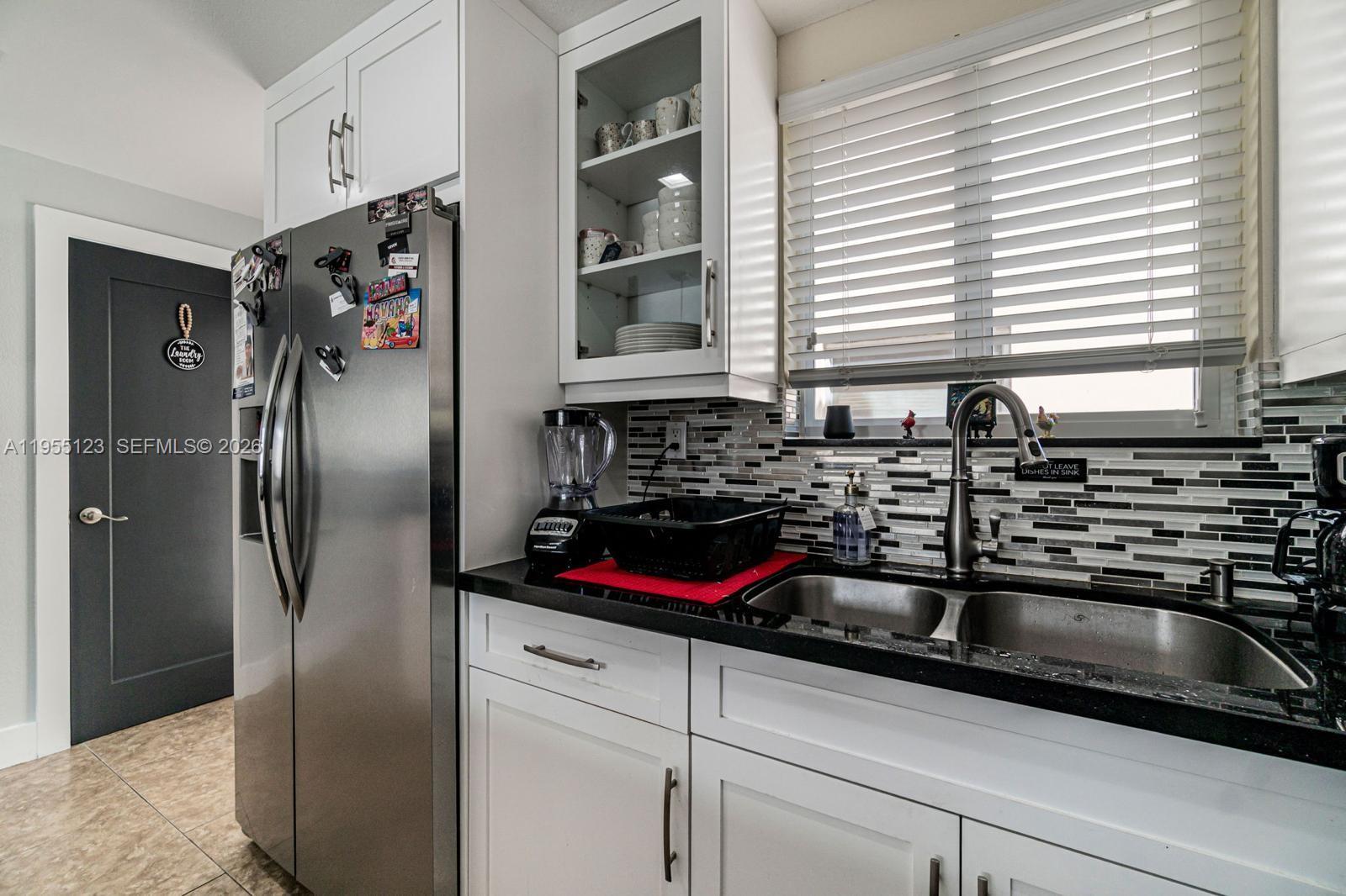 901 Northwest 22nd Place Miami, FL 33125 - Photo 12 of 52 a kitchen with a sink cabinets and window