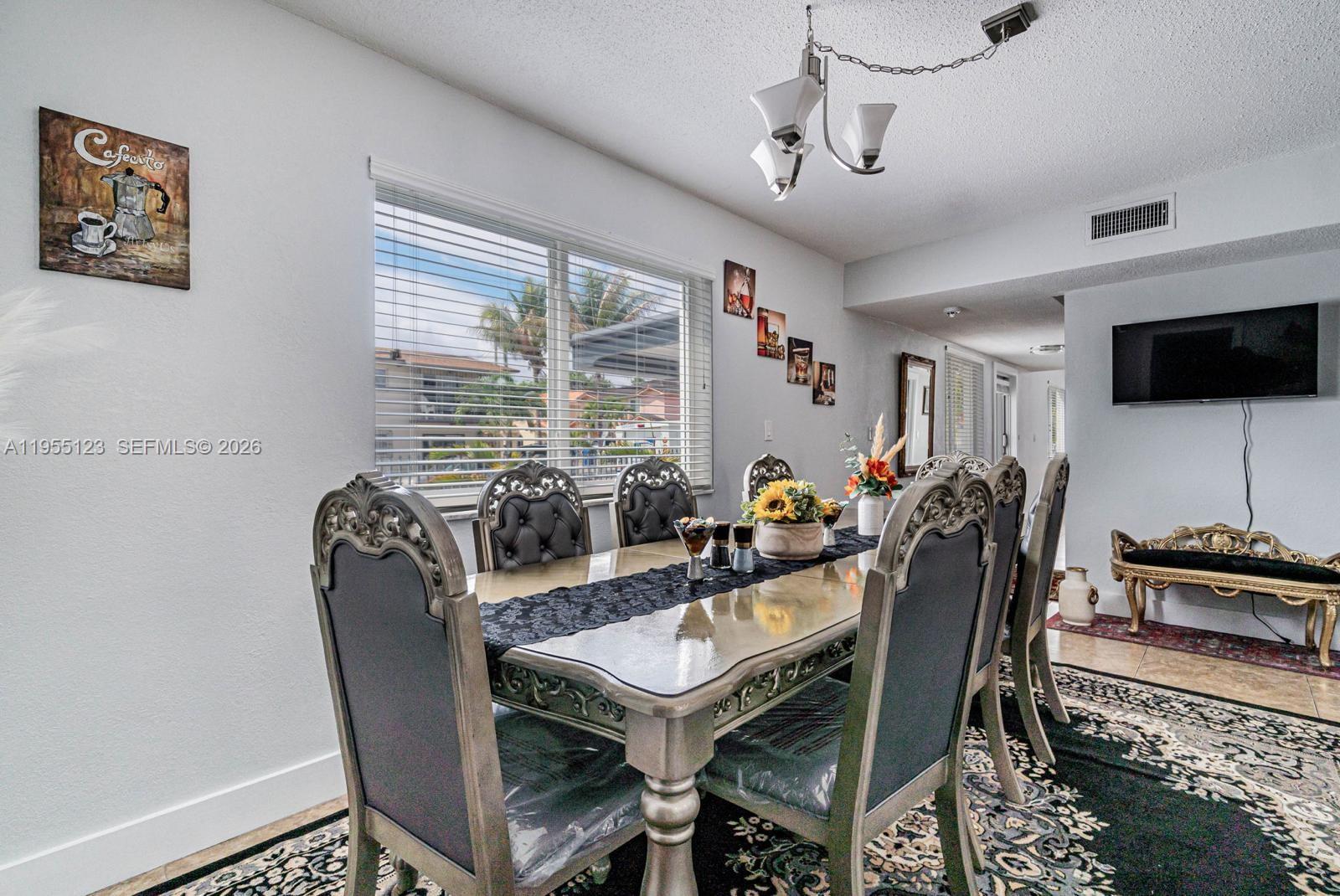 901 Northwest 22nd Place Miami, FL 33125 - Photo 16 of 52 a dining room with furniture and window