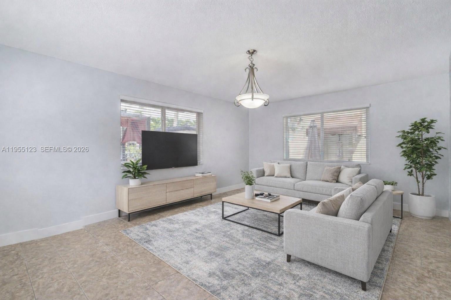 901 Northwest 22nd Place Miami, FL 33125 - Photo 7 of 52 a living room with furniture and a flat screen tv