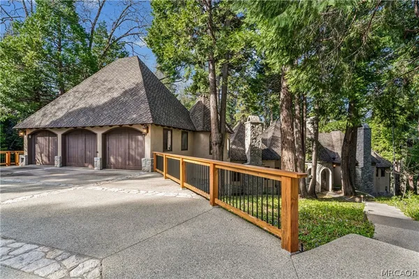 a view of a house with wooden fence next to a road