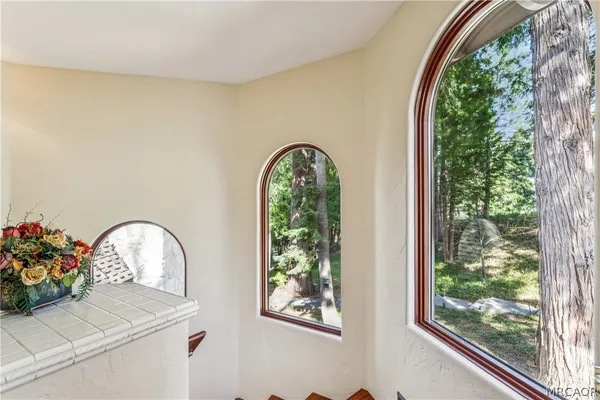 a view of a patio with table and chairs and floor to ceiling window