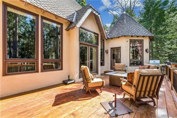 a backyard of a house with outdoor seating