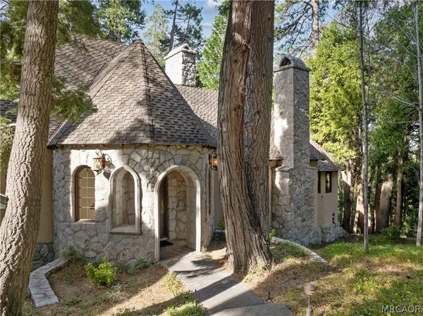 a living room with fireplace furniture and a chandelier