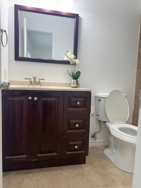 3410 Maple Lane Rowlett, TX 75089 - Photo 5 of 8 a bathroom with a toilet a sink and mirror