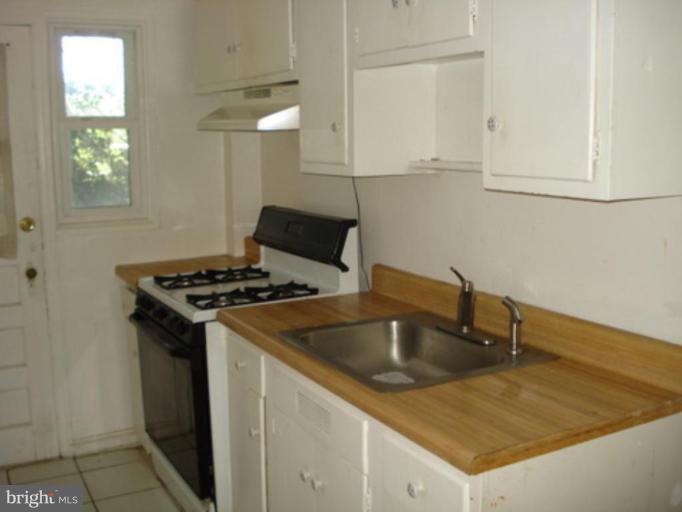 5424 Channing Road Baltimore, MD 21229 - Photo 4 of 5 a kitchen that has a sink and a stove