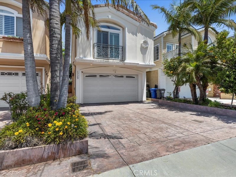 a front view of a house with a yard and a garage