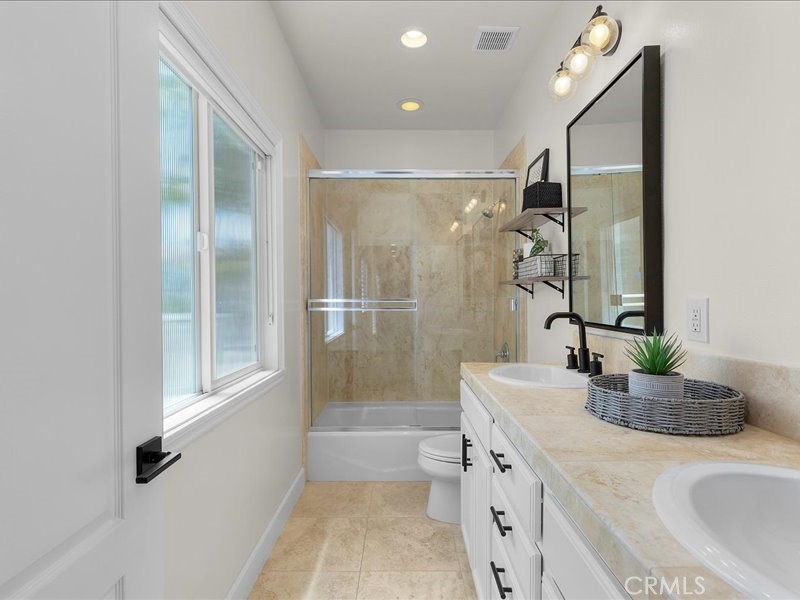 1729 Haynes Lane Redondo Beach, CA 90278 - Photo 31 of 44 a bathroom with a granite countertop sink a mirror and shower