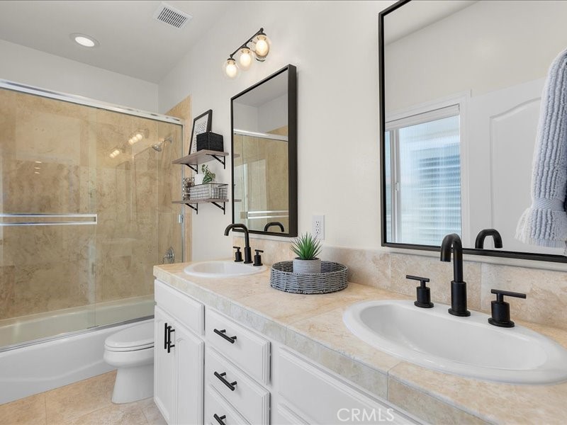 1729 Haynes Lane Redondo Beach, CA 90278 - Photo 33 of 44 a bathroom with a double vanity sink toilet mirror and shower