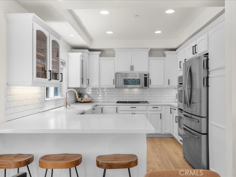 1729 Haynes Lane Redondo Beach, CA 90278 - Photo 4 of 44 a kitchen with stainless steel appliances a refrigerator stove microwave and cabinets