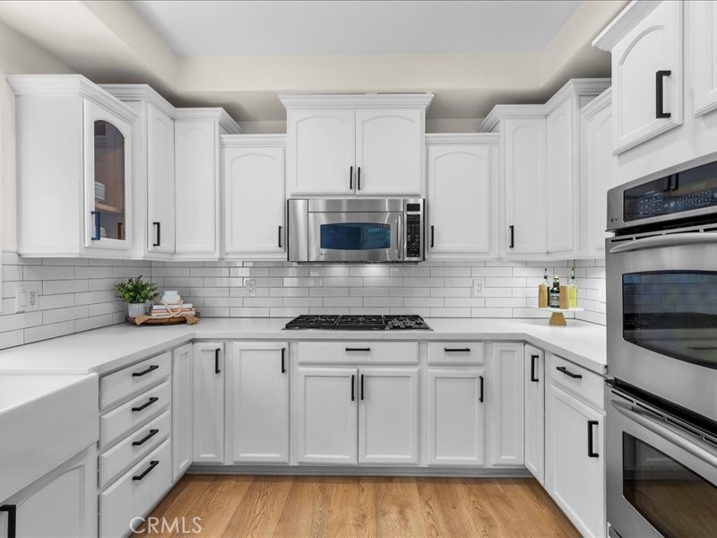 1729 Haynes Lane Redondo Beach, CA 90278 - Photo 7 of 44 a kitchen with granite countertop white cabinets and stainless steel appliances