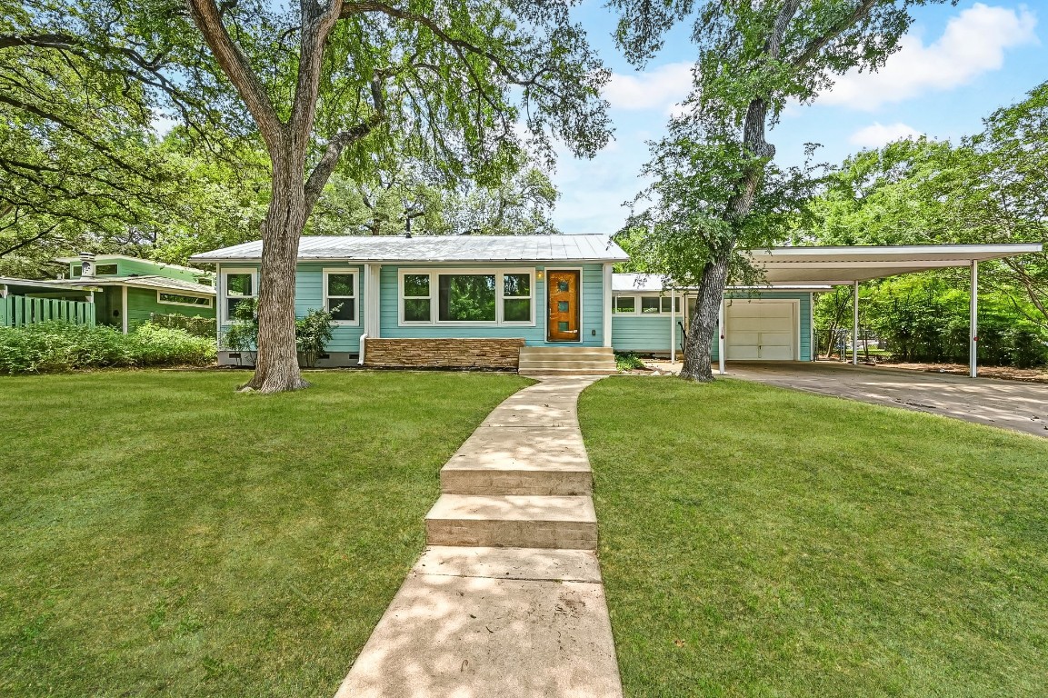 4928 Strass Drive Austin, TX 78731 - Photo 1 of 1 front view of a house with a yard