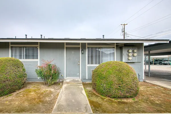 a view of a house with a backyard and garage