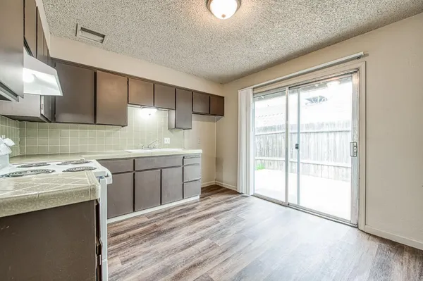 a kitchen with a stove a sink and a microwave